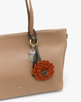 Handbag with flower keychain and keys attached