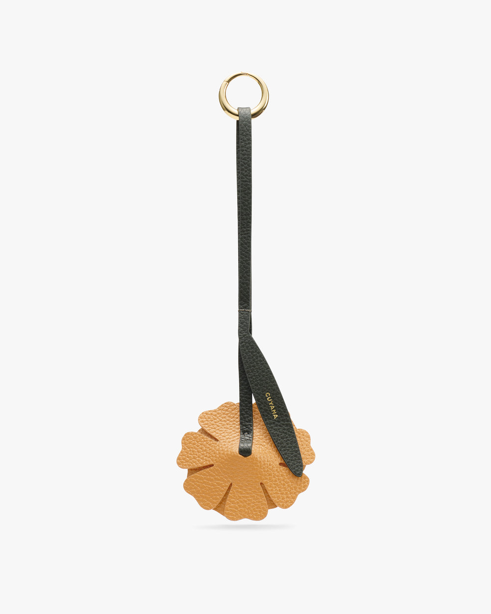 Keychain with a round leather flower charm and a strap with a ring attachment.