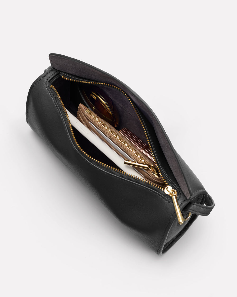 Open bag with items like wallets and sunglasses inside.