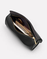 Open bag with items like wallets and sunglasses inside.