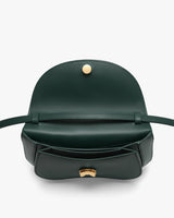 Open handbag with a flap and button closure, featuring interior compartments.