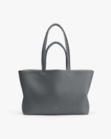 Large tote bag with long handles on plain background