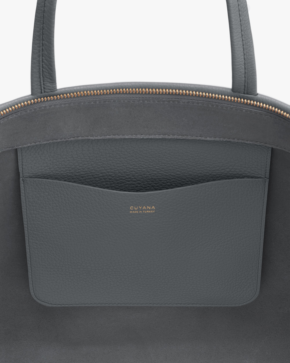 Leather handbag close-up with open pocket and brand logo.