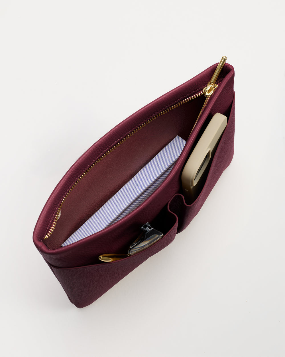 Open handbag with notebook and phone inside