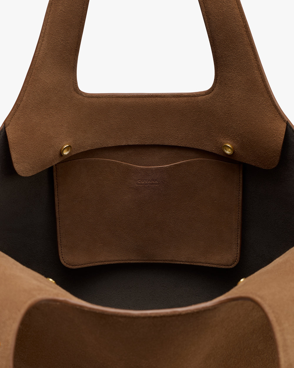 Open tote bag with interior pocket and brass buttons.