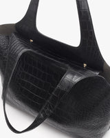 Croc-embossed leather travel bag with short handles.