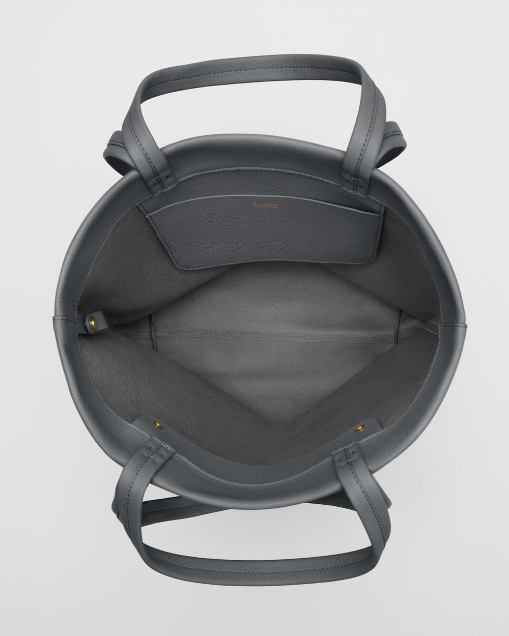 Top view of an open handbag with handles and inner pocket.