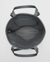 Top view of an open handbag with handles and inner pocket.