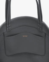 Round handbag with open external pocket and two handles