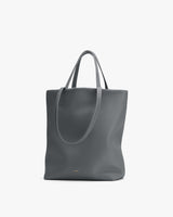 Large tote bag with thin handles on display.