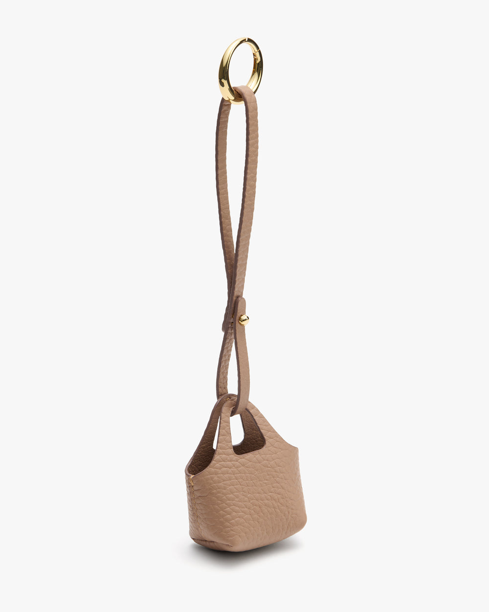 Small textured handbag with a long strap and circular metal handle attachment.