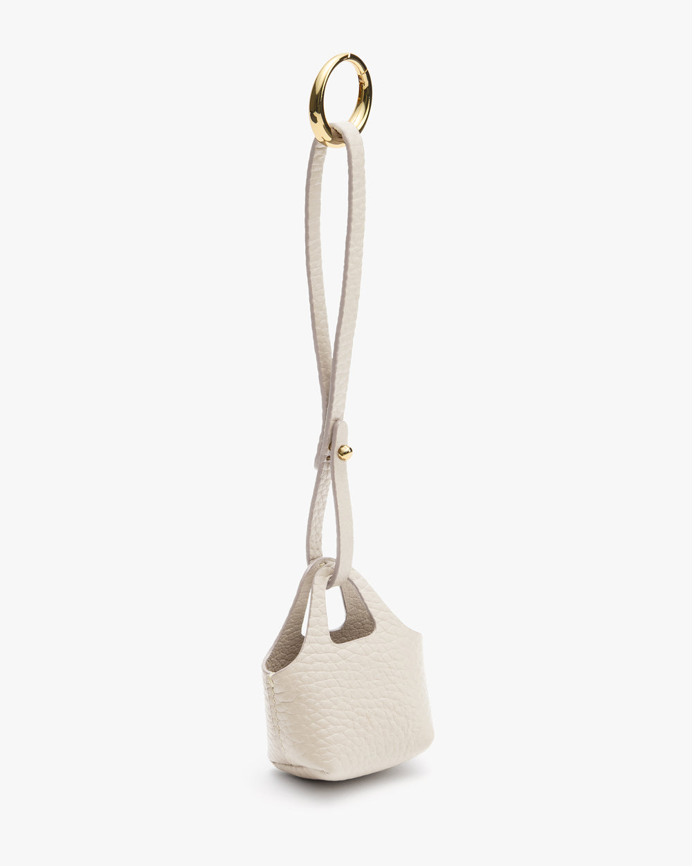 Small textured handbag with long handle and metal ring.