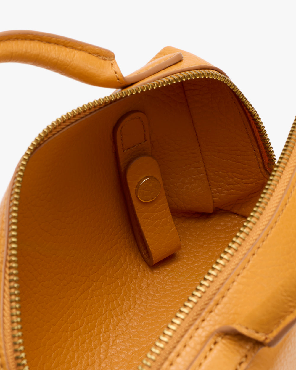 Open travel bag with visible strap and zipper.