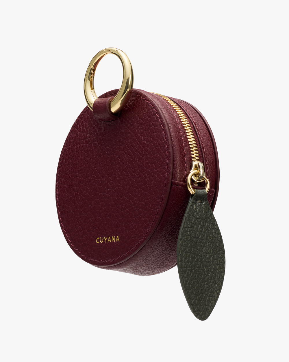 Round leather pouch with a zipper and metal ring attachment.