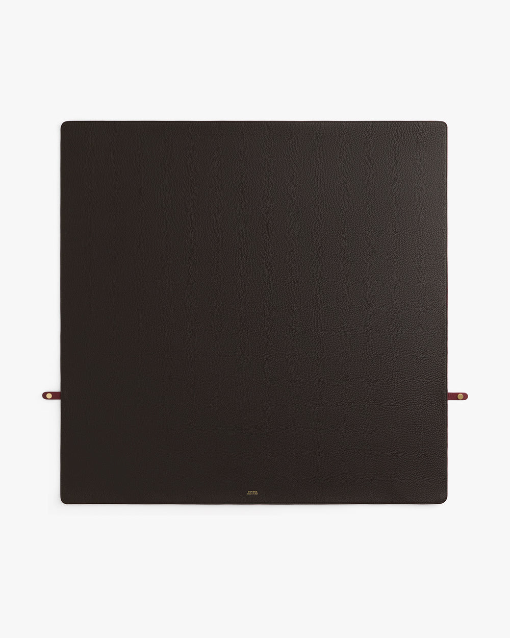 Square leather desk mat with small strap loops on two sides.