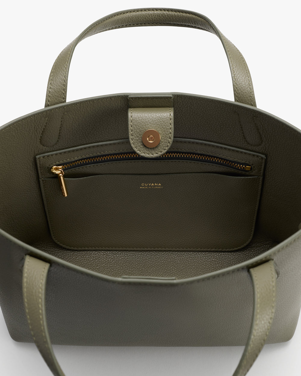 Open handbag showing inside pocket with zipper and button closure.