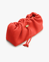 Rectangular scrunched clutch bag with drawstring closure.