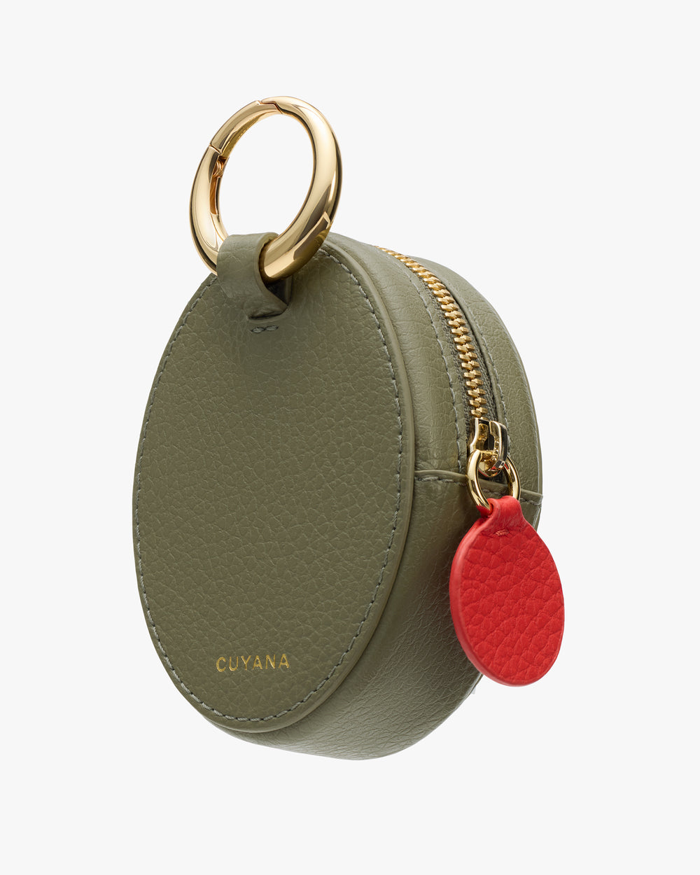 Small round pouch with a zipper and a metal ring handle, featuring a contrasting circular charm.