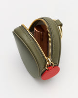 Small bag with zipper partially open, showing cylindrical object inside.