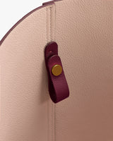 Inside view of a bag with a magnetic closure and textured surface.