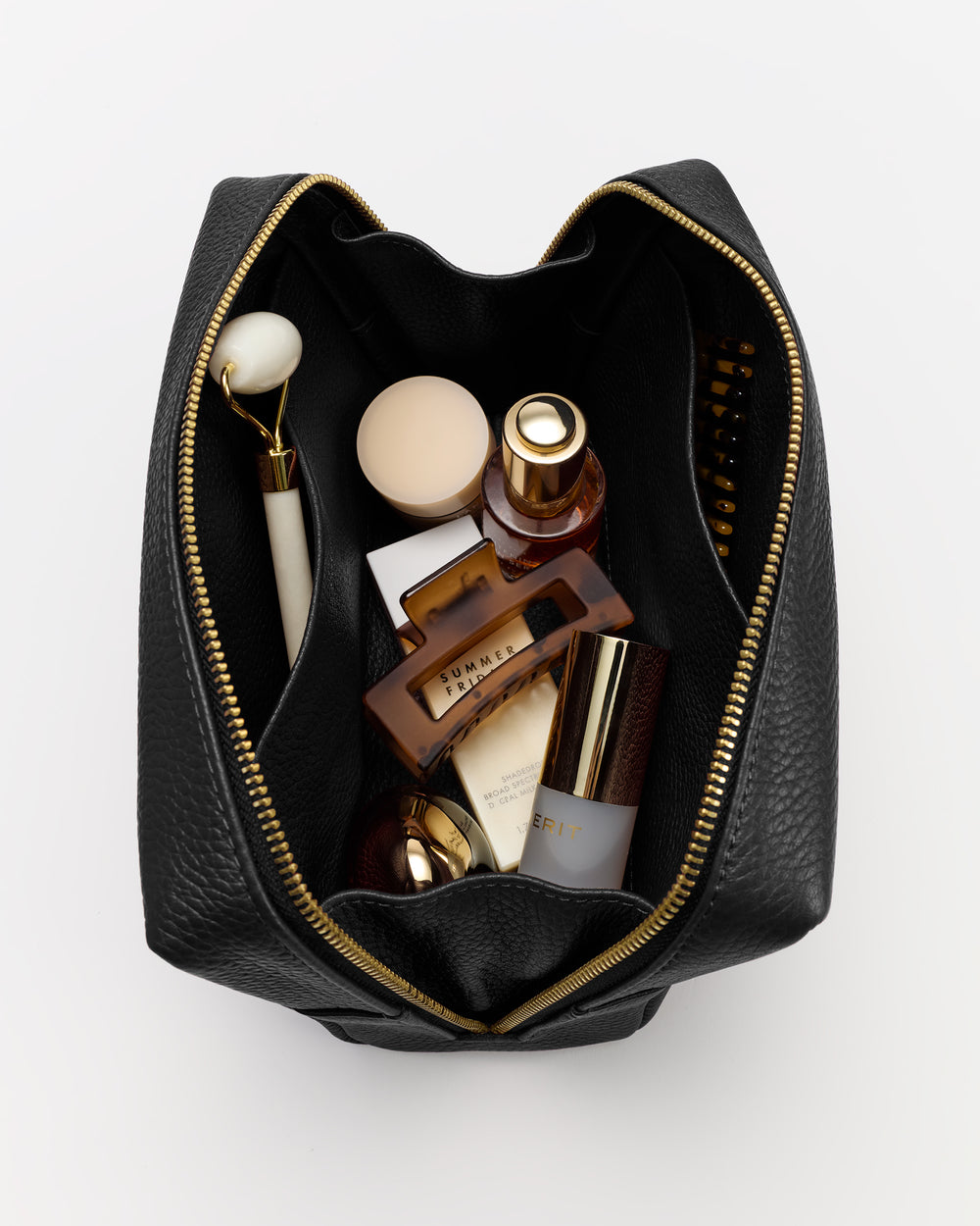 Open travel bag with various toiletries inside