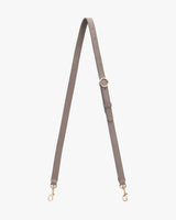 Bag strap with adjustable buckle and metal clasps at both ends.
