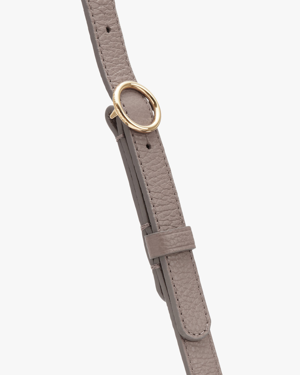 Close-up of a textured leather strap with a round metal buckle.
