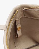 Open leather bag with pocket and button inside.