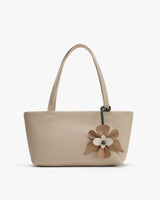 Handbag with floral decoration and two handles.
