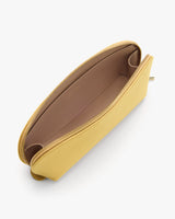 A top view of an open clutch bag with a zipper and spacious interior.