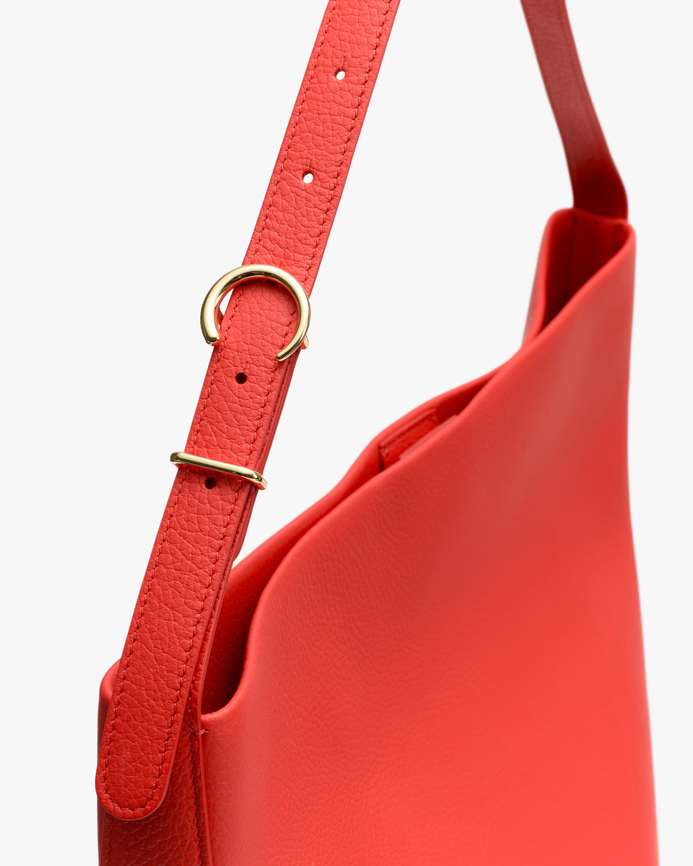 Shoulder bag with adjustable strap and gold buckle.