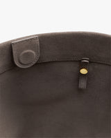 Open top of a bag with button closure inside.