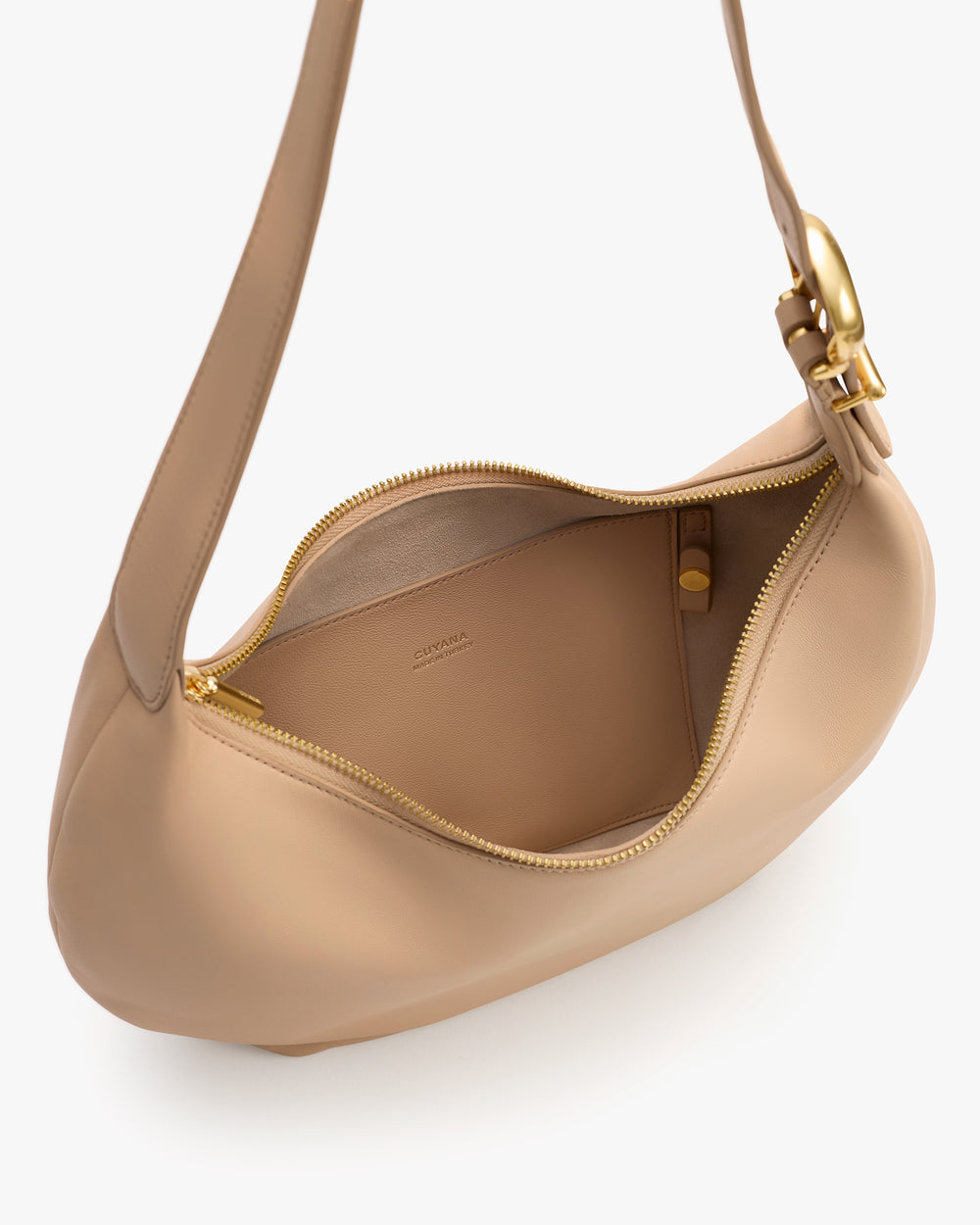 A hobo bag with a zipper partially open showing interior lining and a clasp on the strap.