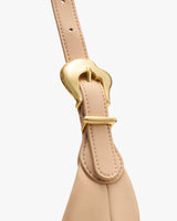 Close-up of a bag strap with a metal buckle.