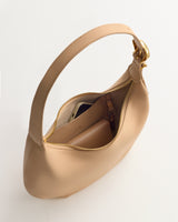 Hobo bag with gold clasp, open to show phone and wallet inside.