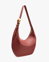 Shoulder bag with a curved shape and a strap with a buckle.