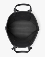 Top view of an open travel bag with handles and a pocket inside.