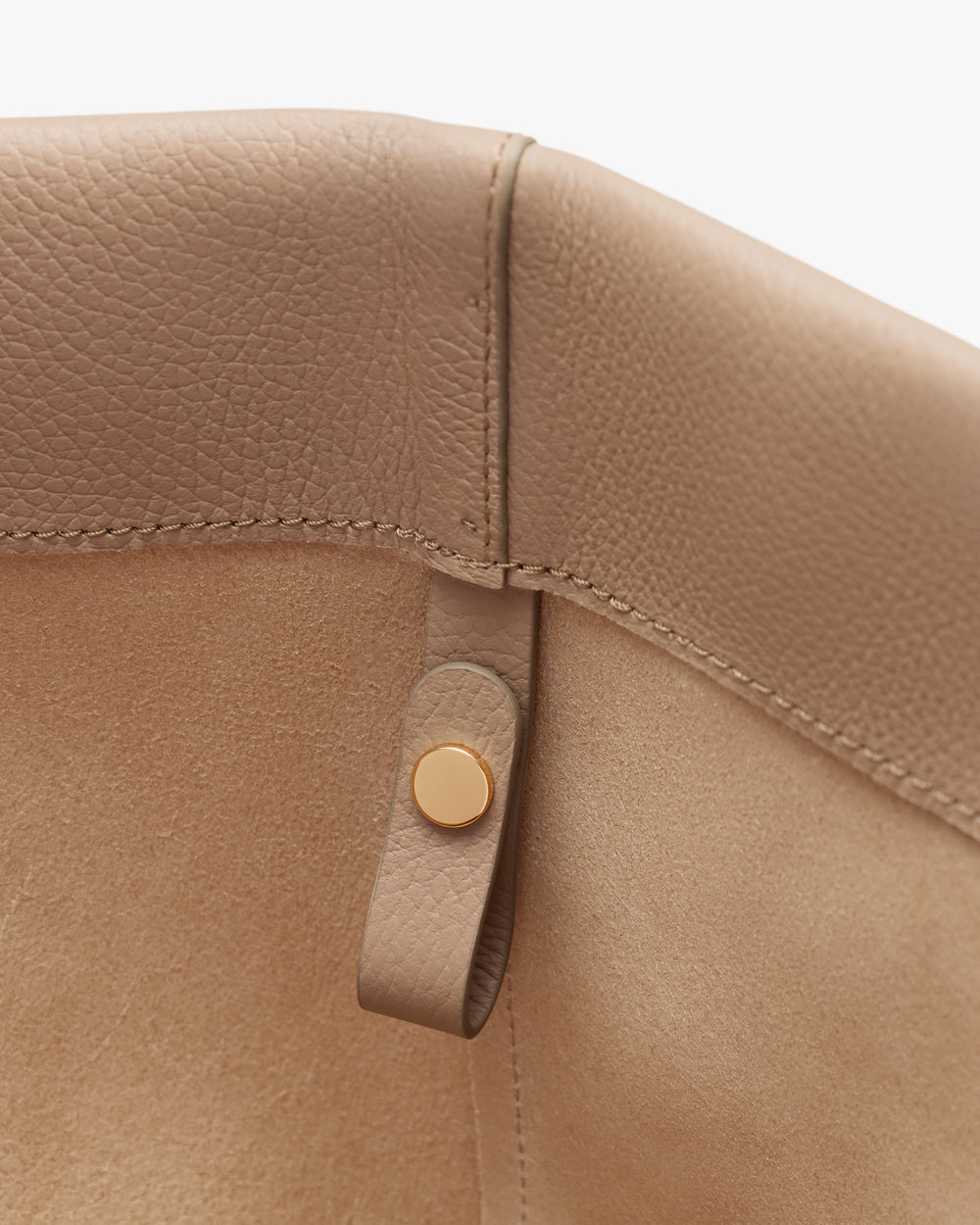 Close-up of leather bag interior with button detail.
