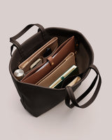 Open tote bag with organized pouches and a notebook inside.