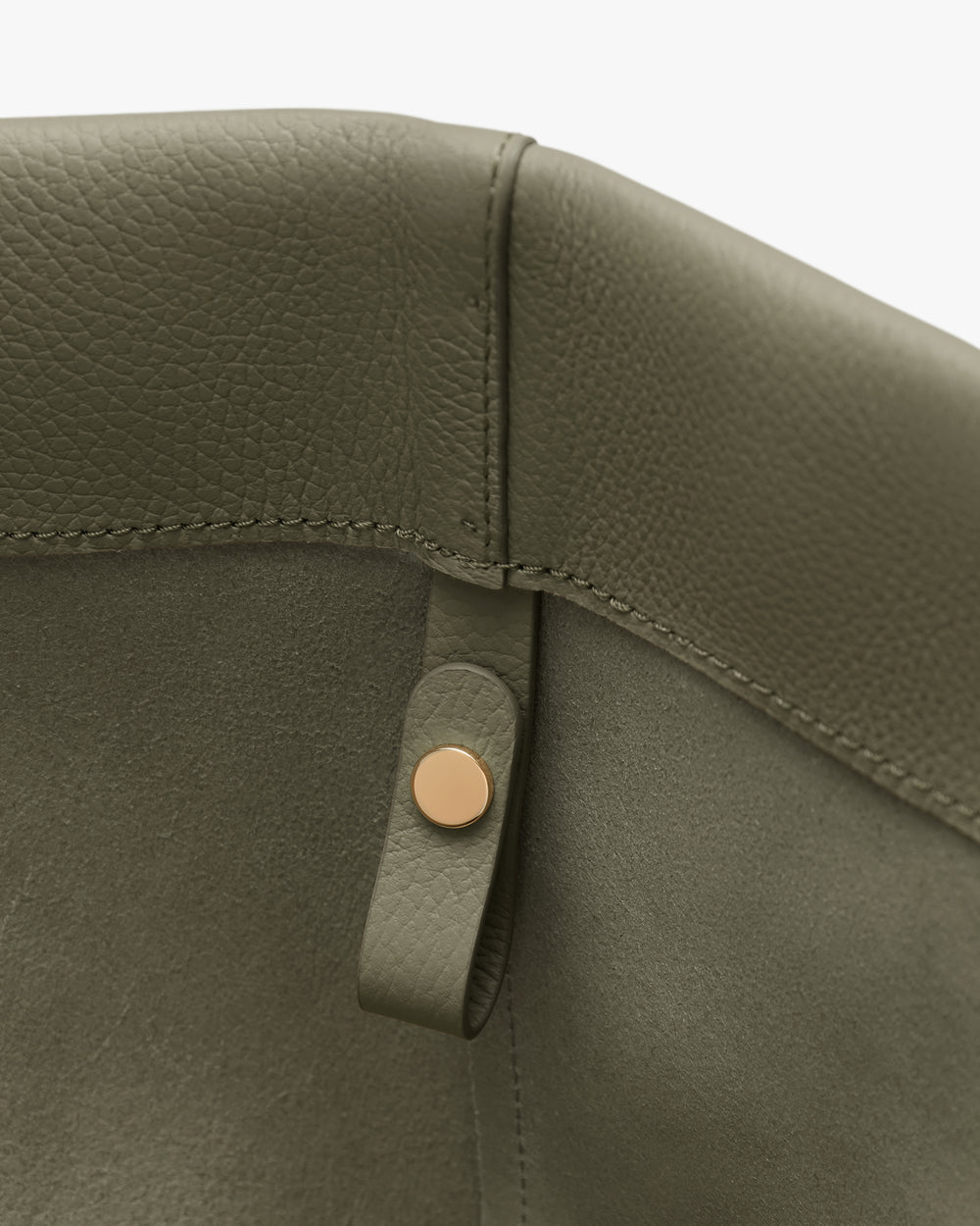 Close-up of a textured bag interior with a button detail.