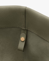Close-up of a textured bag interior with a button detail.
