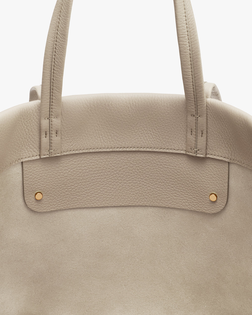 Tote bag with two handles and small gold studs.