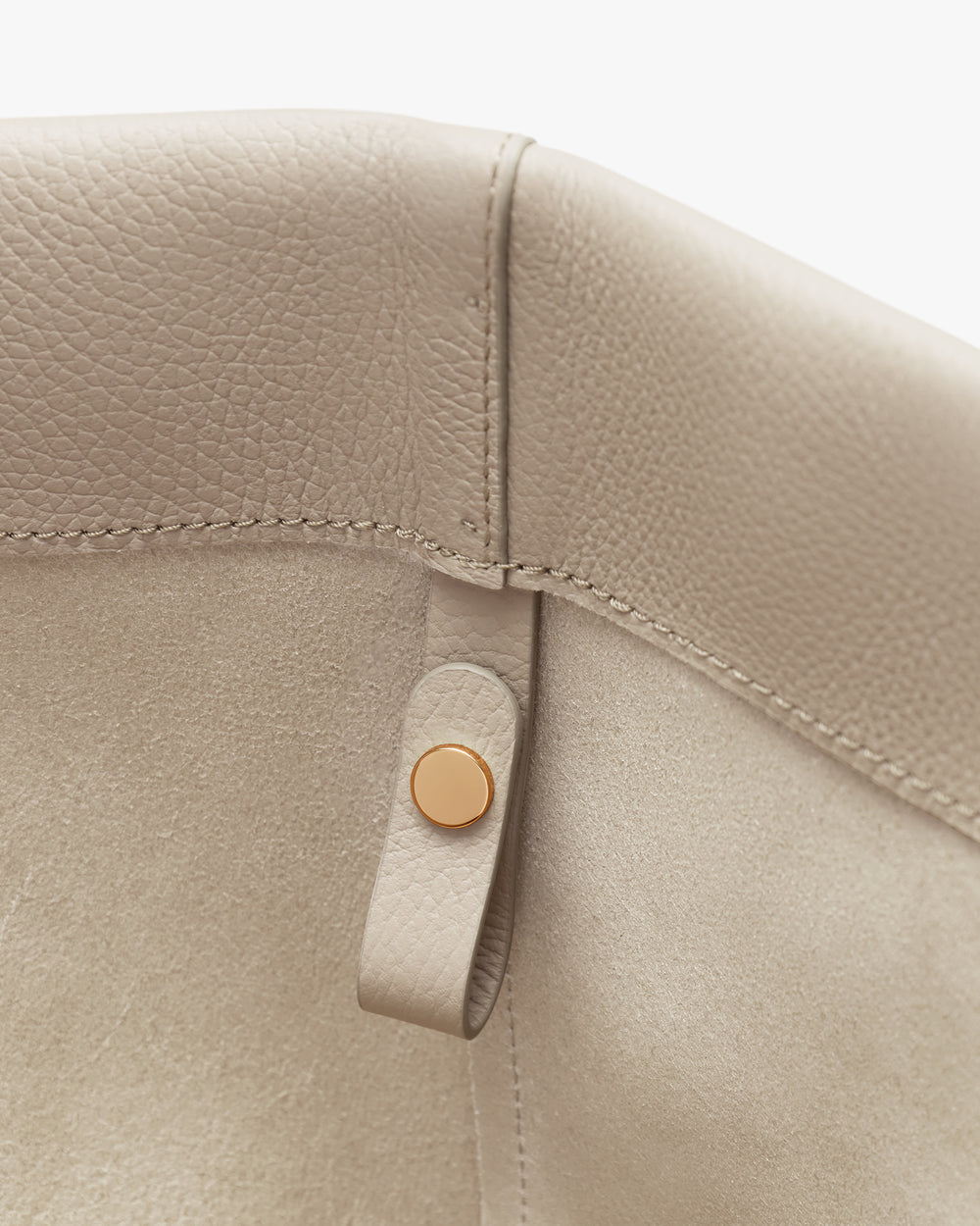 Close-up of a bag corner with button detail.