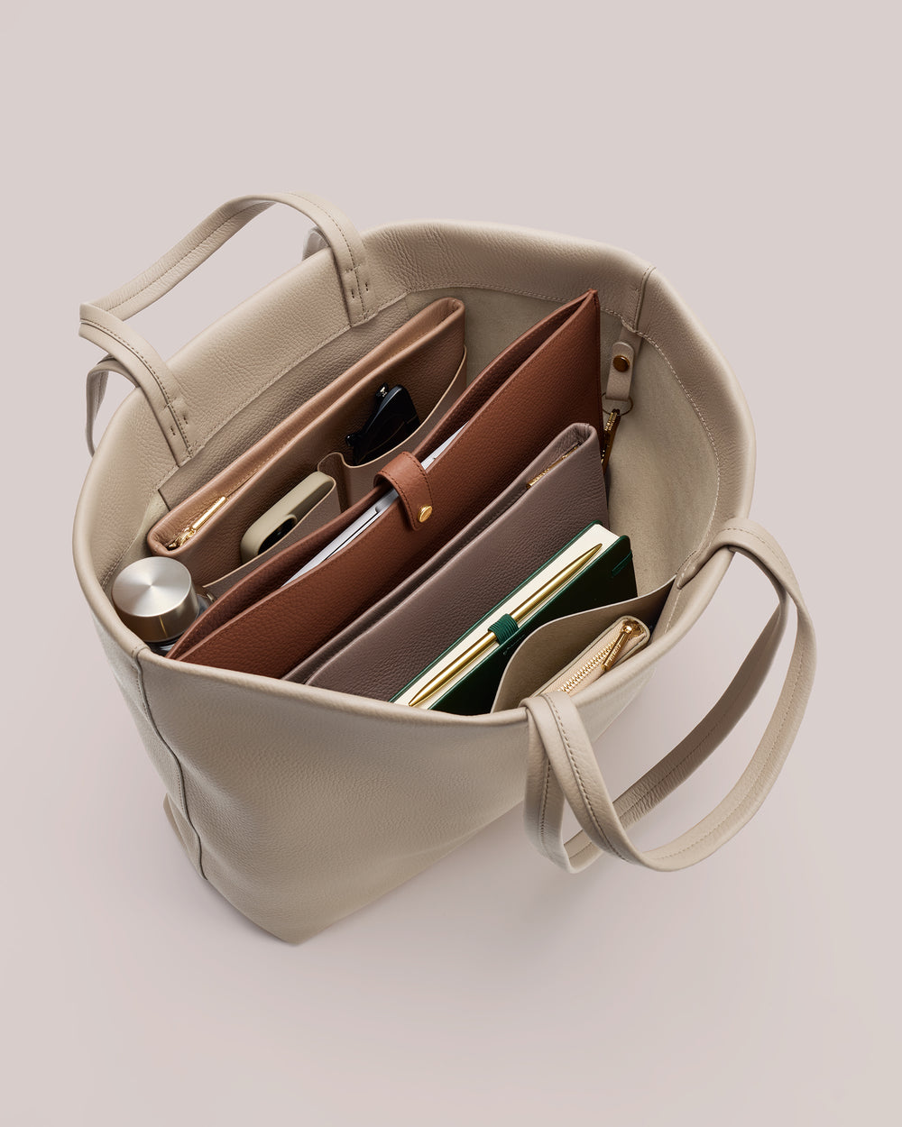 Open handbag filled with organized items and accessories.