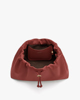 Open travel bag with interior pouch visible.