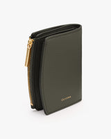 Compact folded wallet with zipper and logo.