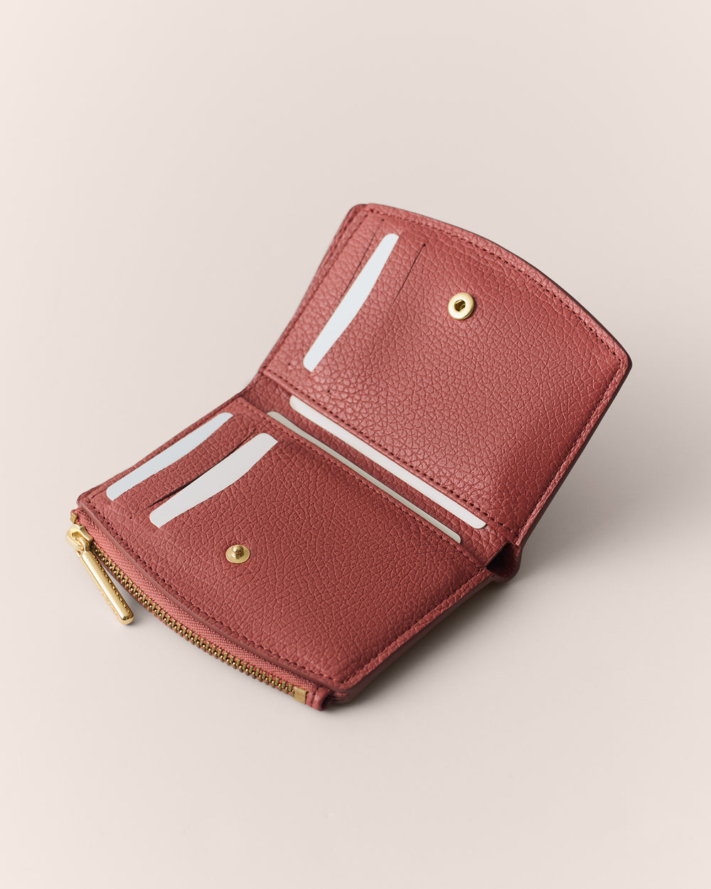 Open wallet with several card slots and a zipper compartment.