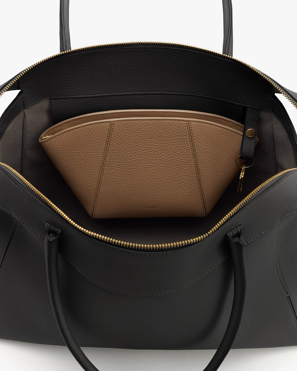 Open travel bag with a zippered pocket inside.