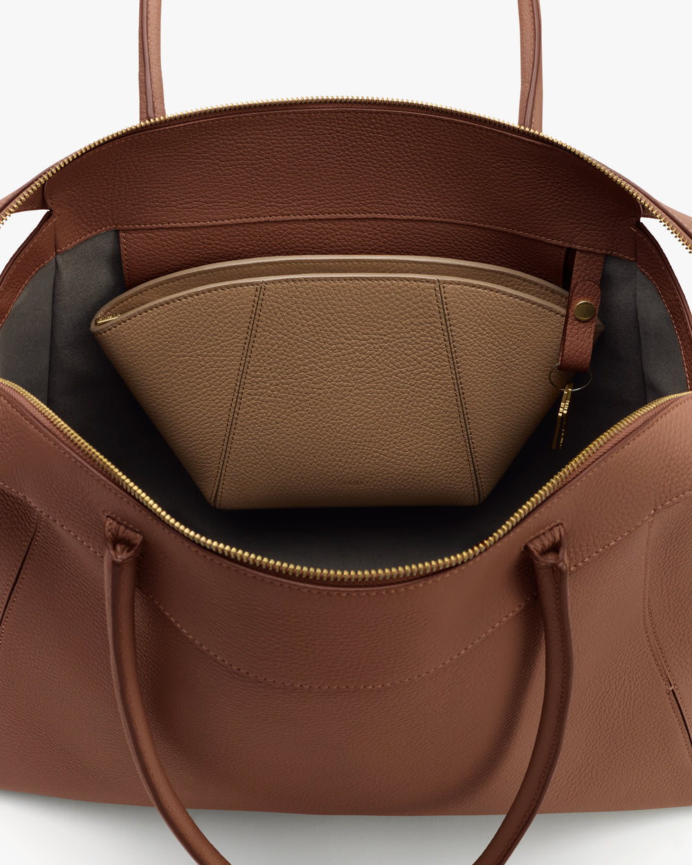 Open travel bag with a zipped compartment inside.
