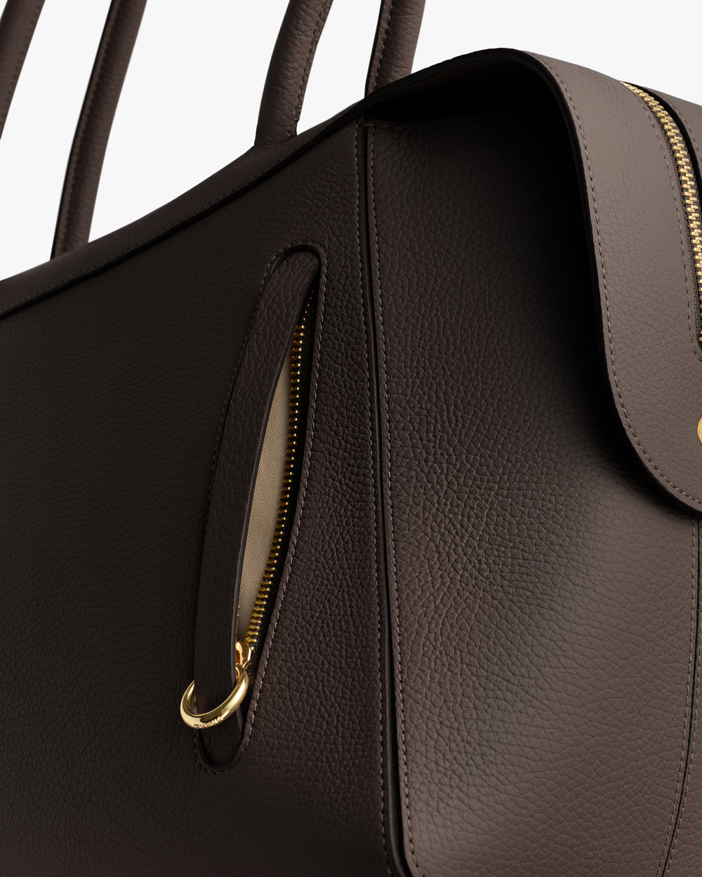 Close-up of handbag with zipper and handles.